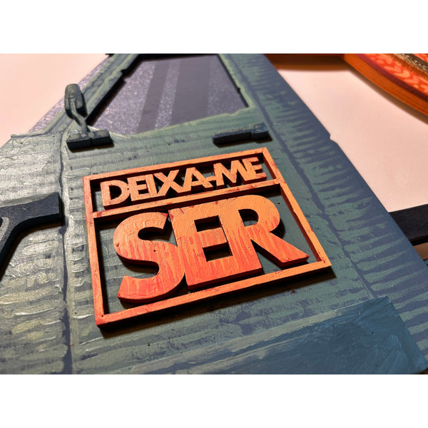 Detailed view of the original acrylic painting on layered wood "Deixa-me ser" by Mário Belém, highlighting the expressive hand-painted typography, the intricate graphic elements, and the depth of the overlapping wood layers.