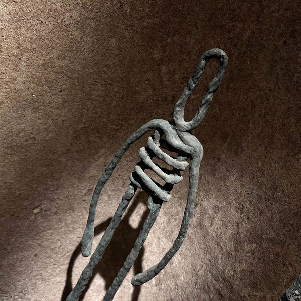 Detailed view of the bronze casting and finish of the sculpture "Last Man Standing" by RAM.