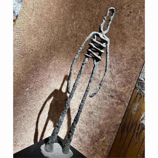 Detailed view of the bronze casting and finish of the sculpture "Last Man Standing" by RAM.